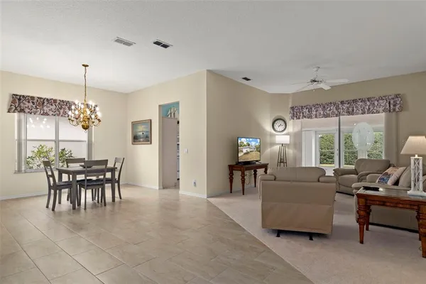 a living room with furniture a window and a flat screen tv