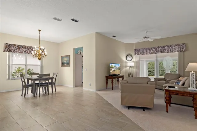 a living room with furniture a window and a flat screen tv