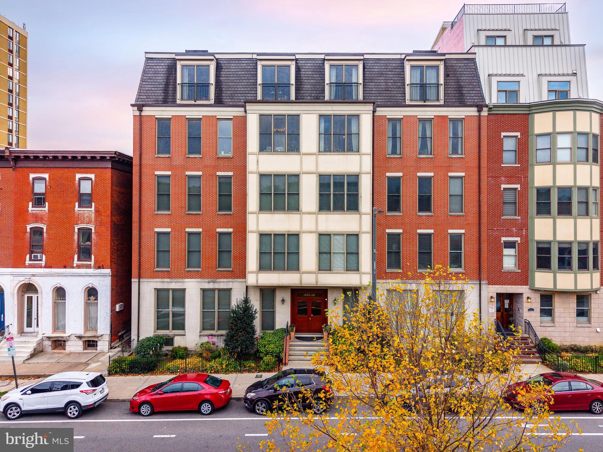 1910 Spring Garden Street, Unit 1 Philadelphia, PA 19130 - Photo 1 of 39 a front view of a building with lot of cars parked