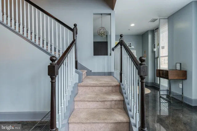 a view of entryway and hall with wooden floor