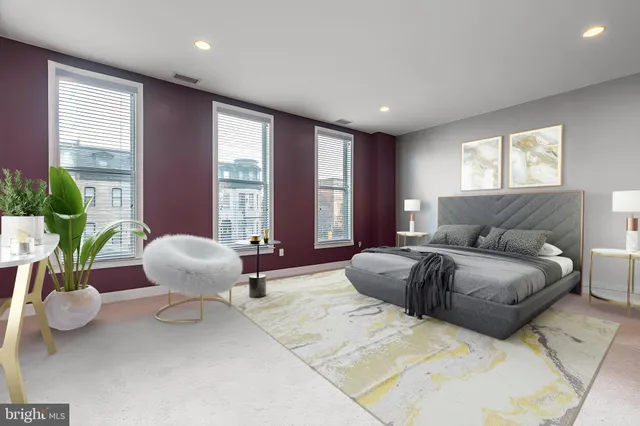 a spacious bedroom with a bed and a large window