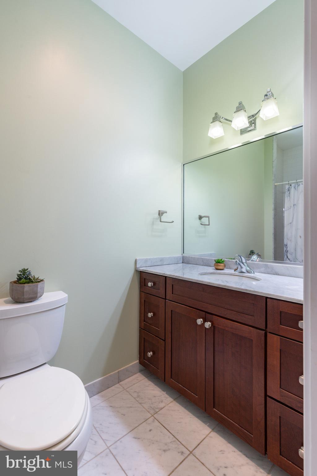 1910 Spring Garden Street, Unit 1 Philadelphia, PA 19130 - Photo 22 of 35 a bathroom with a toilet sink and mirror