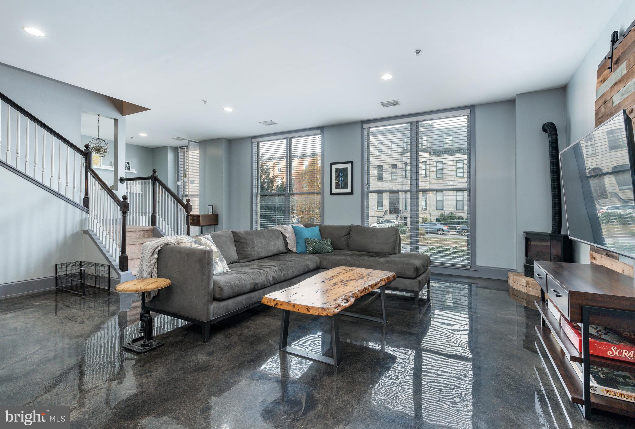 1910 Spring Garden Street, Unit 1 Philadelphia, PA 19130 - Photo 5 of 39 a living room with furniture a flat screen tv and a window