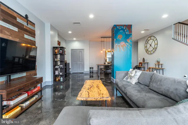 a living room with furniture and a flat screen tv