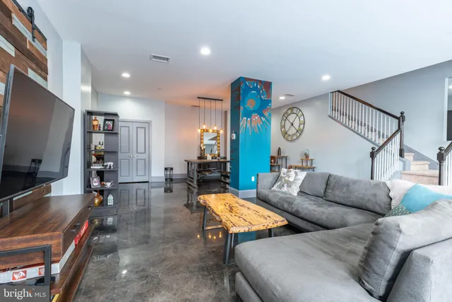 a living room with furniture and a flat screen tv