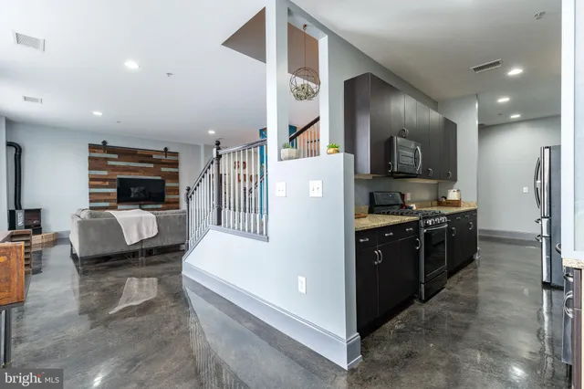 a kitchen with a refrigerator and a stove top oven