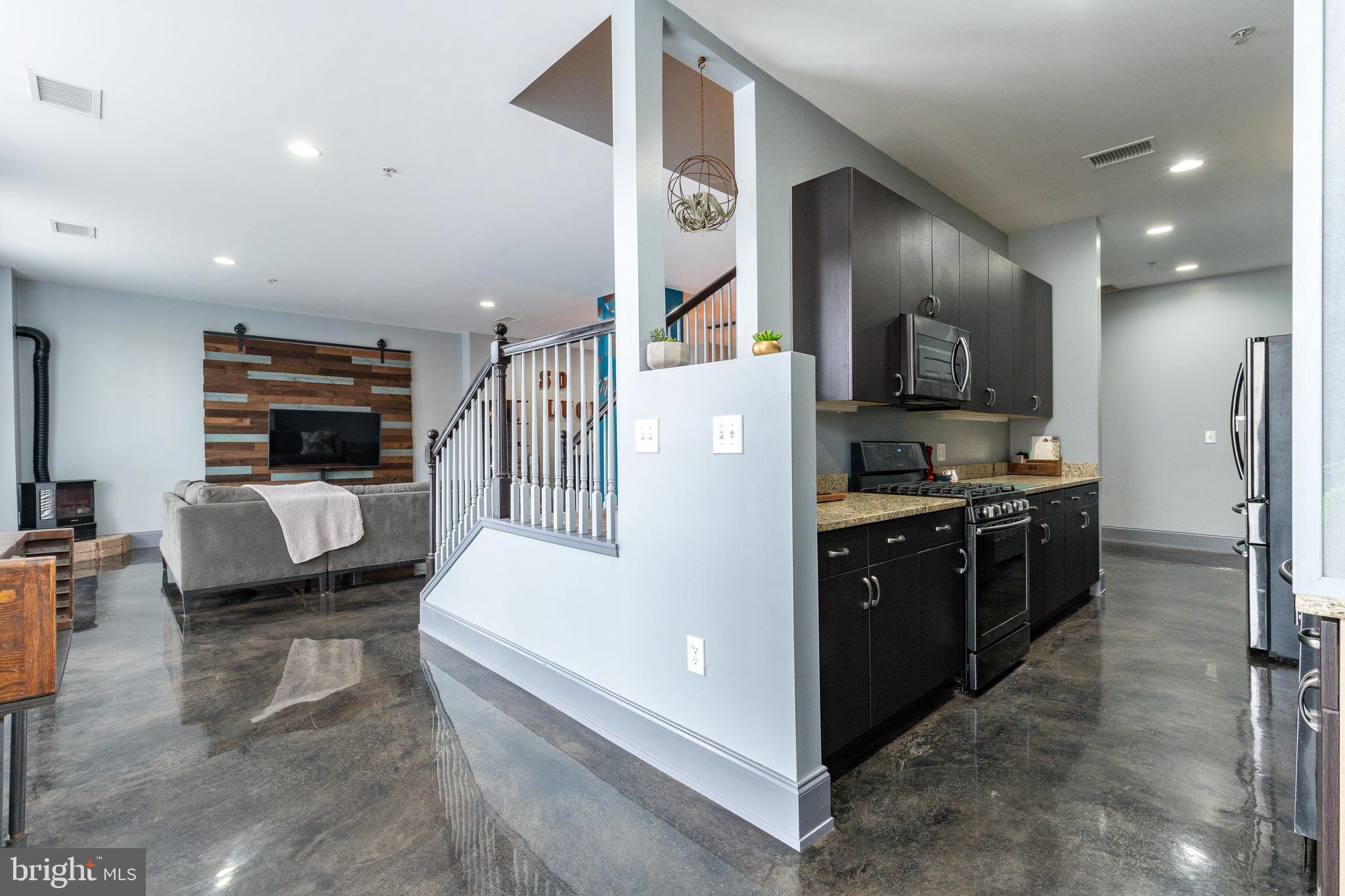 1910 Spring Garden Street, Unit 1 Philadelphia, PA 19130 - Photo 8 of 39 a kitchen with a refrigerator and a stove top oven