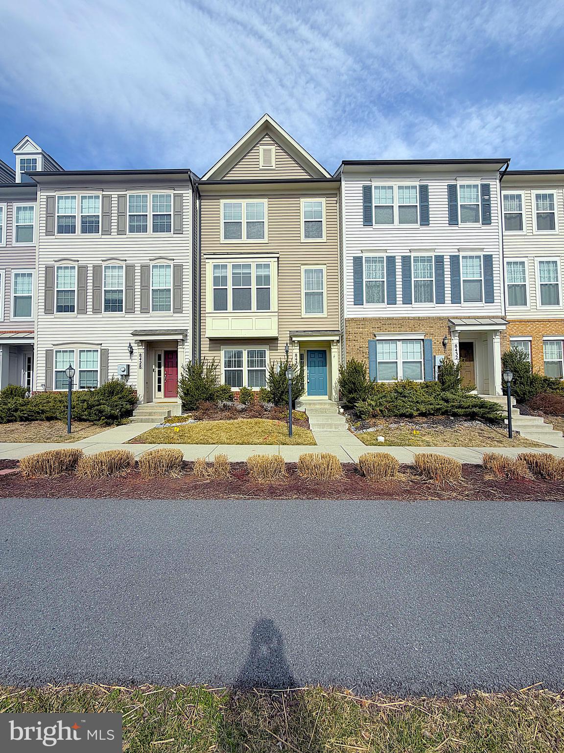 a view of building with lot of windows and trees in the background