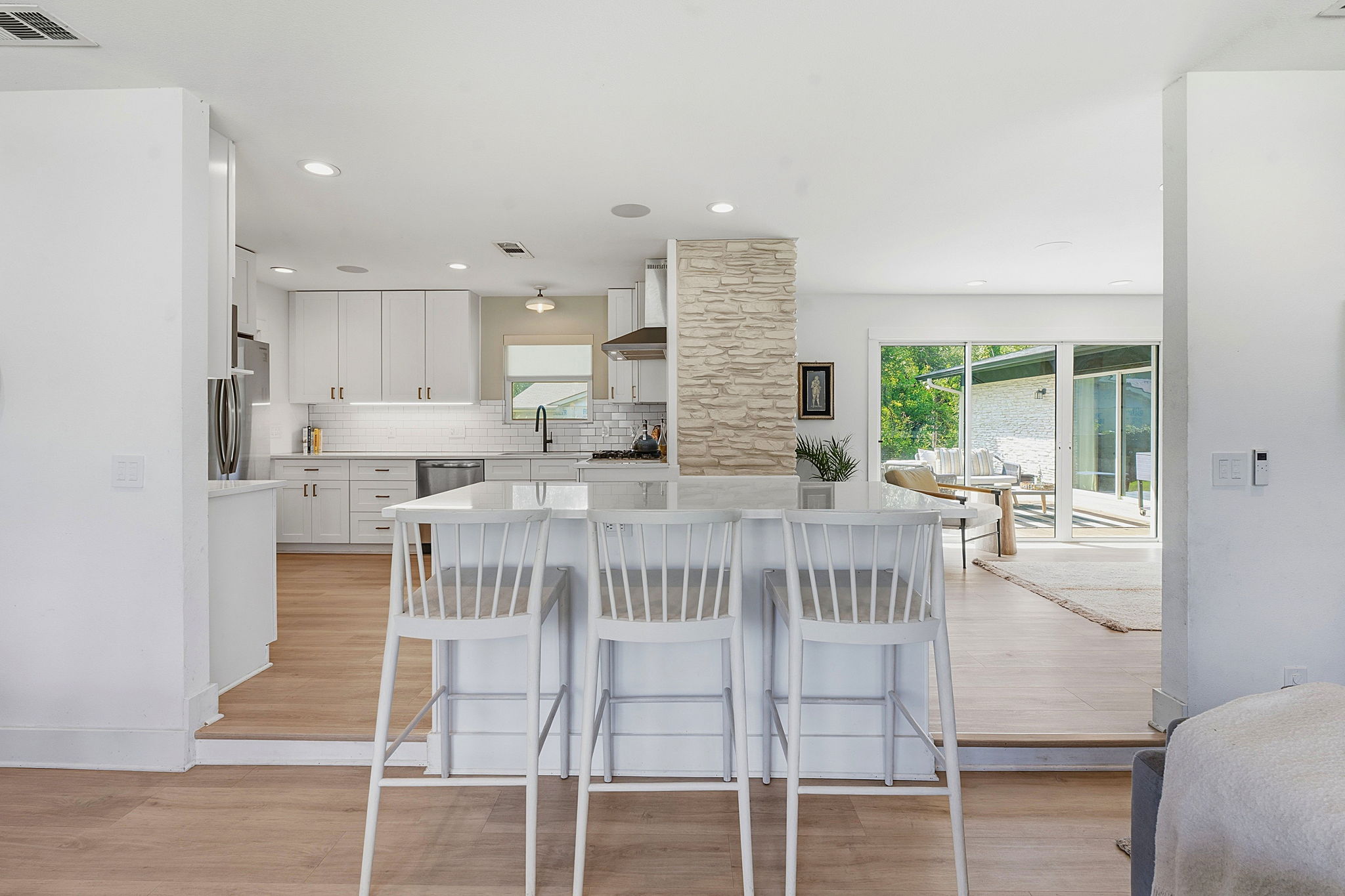 4403 Elmsgrove Drive Austin, TX 78721 - Photo 7 of 38 A pristine kitchen with a central island and a serene view of the outdoors.