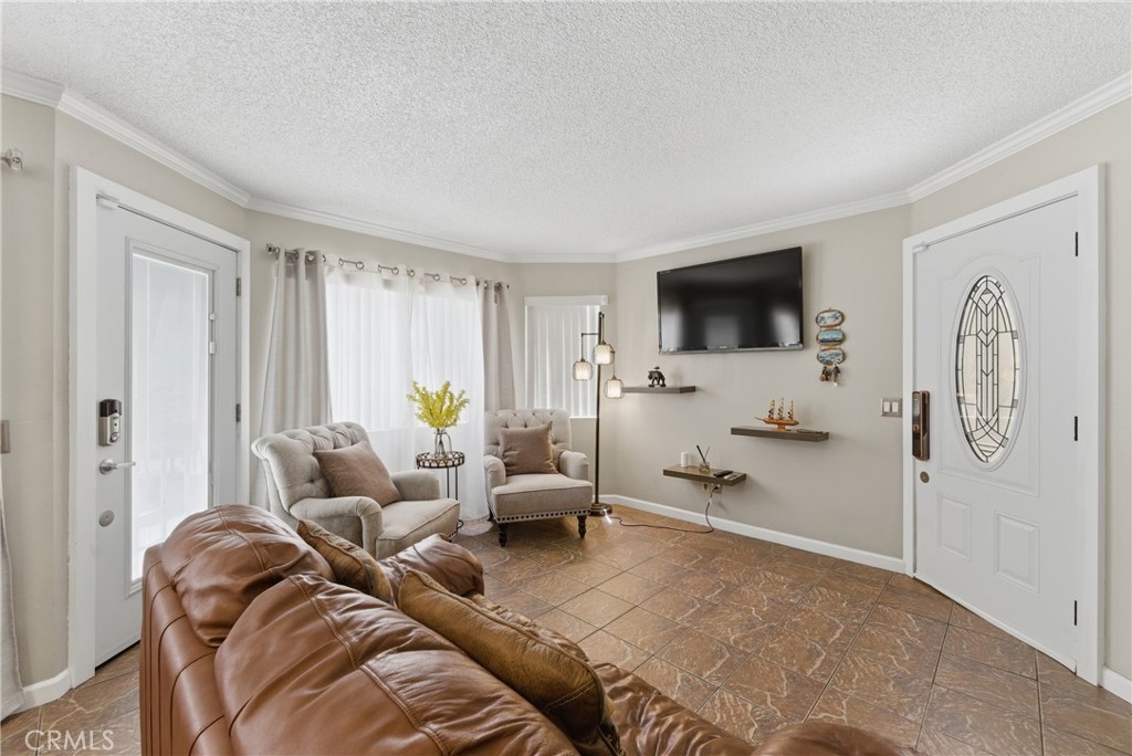 700 West Almond Street Compton, CA 90220 - Photo 11 of 68 a living room with furniture a flat screen tv and a window