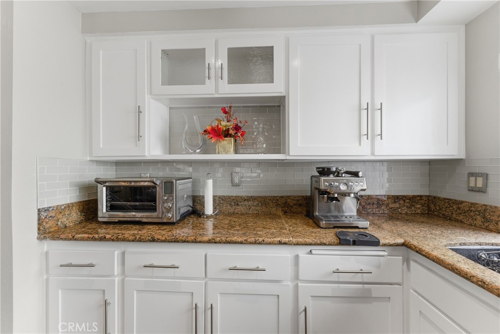 700 West Almond Street Compton, CA 90220 - Photo 16 of 68 a kitchen with granite countertop white cabinets and a stove
