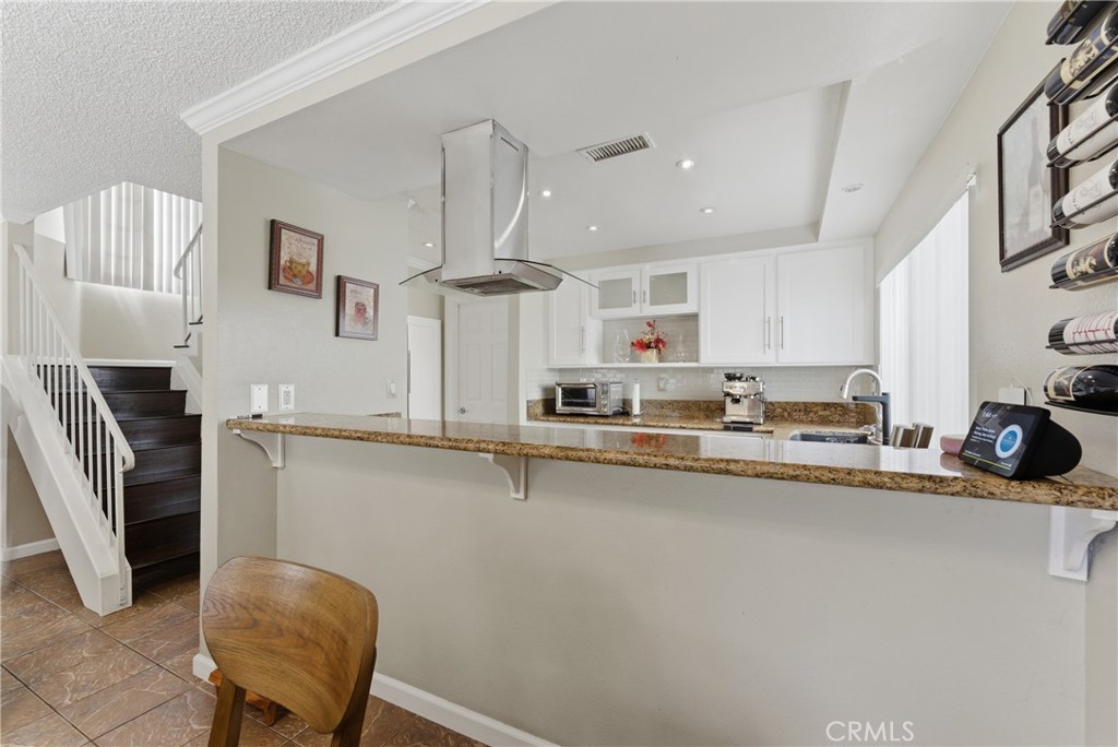 700 West Almond Street Compton, CA 90220 - Photo 23 of 68 a kitchen with stainless steel appliances a sink a stove a refrigerator a counter top space and cabinets