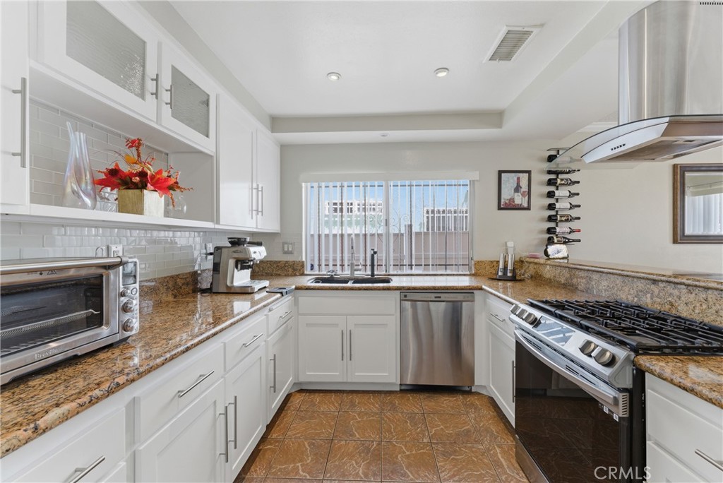 700 West Almond Street Compton, CA 90220 - Photo 24 of 68 a kitchen with stainless steel appliances granite countertop a stove and a sink