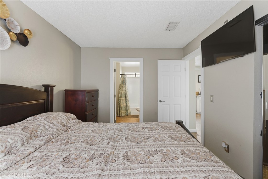 700 West Almond Street Compton, CA 90220 - Photo 28 of 68 a bedroom with a bed and a flat screen tv