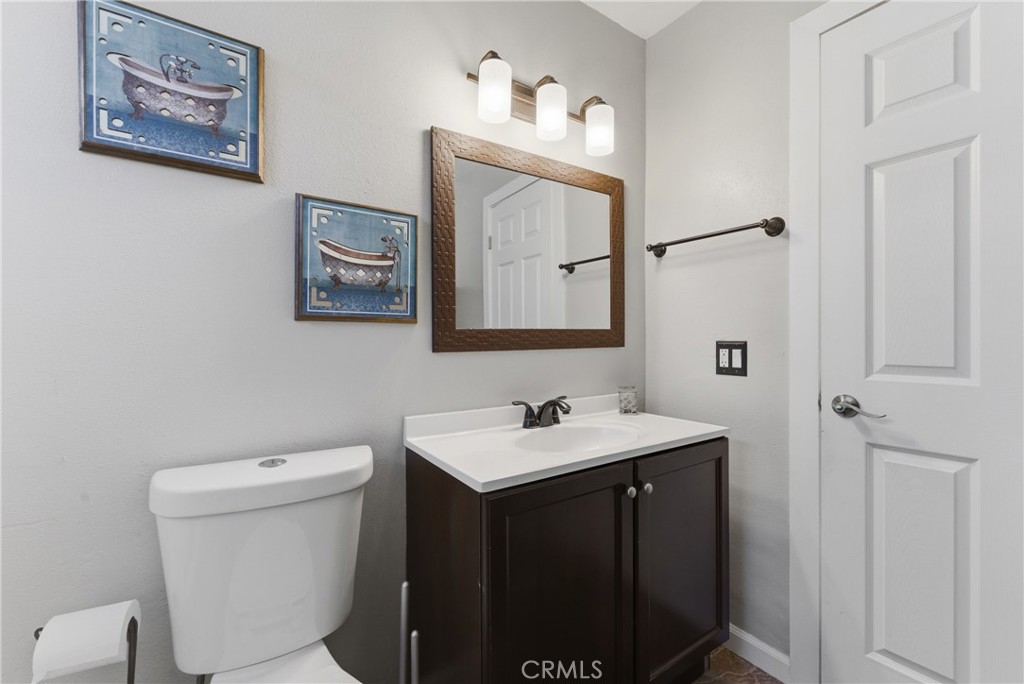 700 West Almond Street Compton, CA 90220 - Photo 31 of 68 a bathroom with a toilet sink and mirror