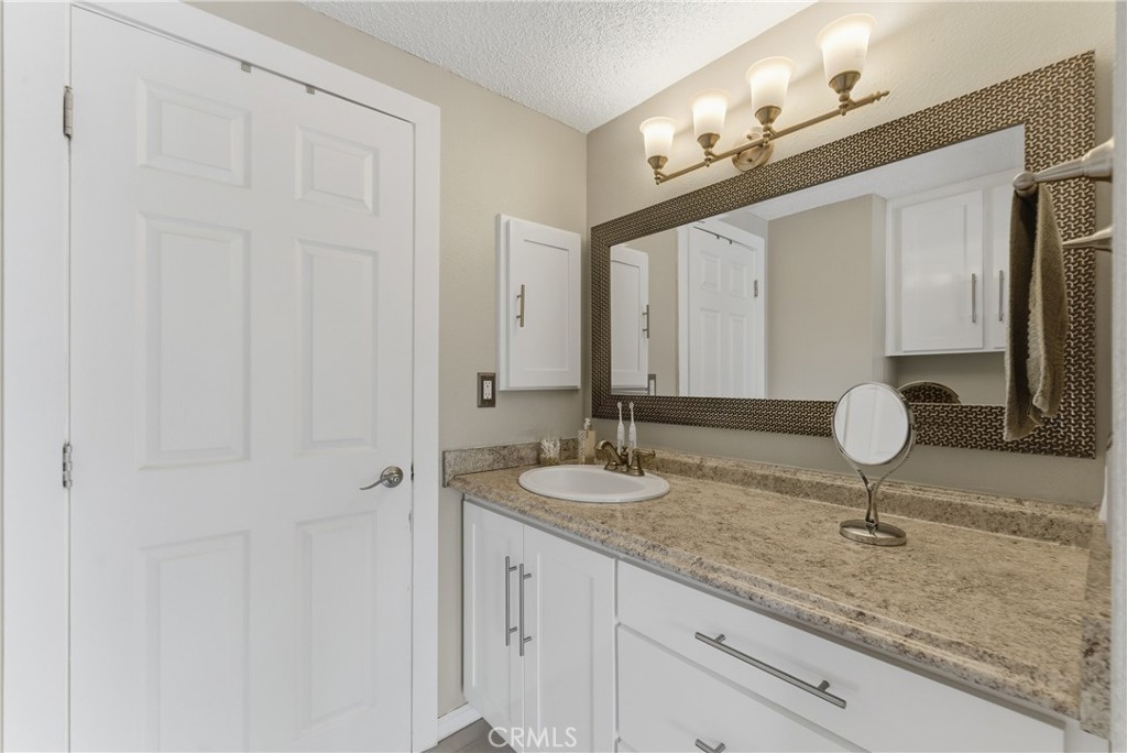 700 West Almond Street Compton, CA 90220 - Photo 49 of 68 a bathroom with a granite countertop sink and a mirror