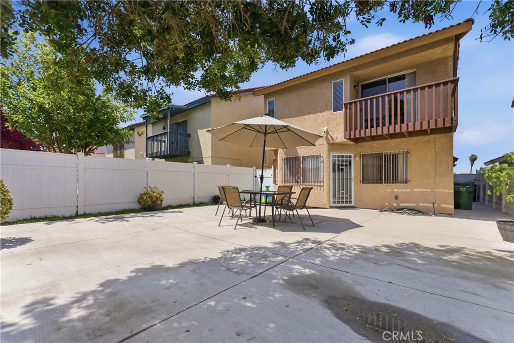 700 West Almond Street Compton, CA 90220 - Photo 57 of 68 a view of a patio with a table and chairs under an umbrella