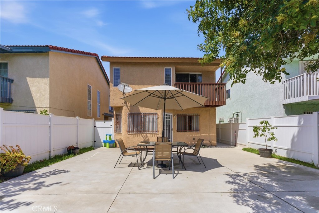 700 West Almond Street Compton, CA 90220 - Photo 58 of 68 a view of a patio with table and chairs potted plants and large tree