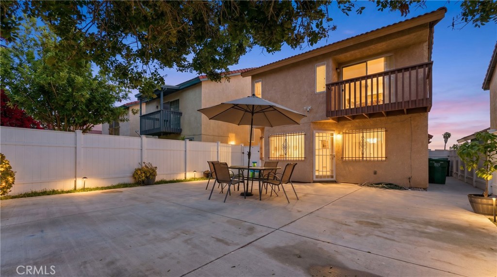 700 West Almond Street Compton, CA 90220 - Photo 62 of 68 a view of a patio with a table and chairs under an umbrella