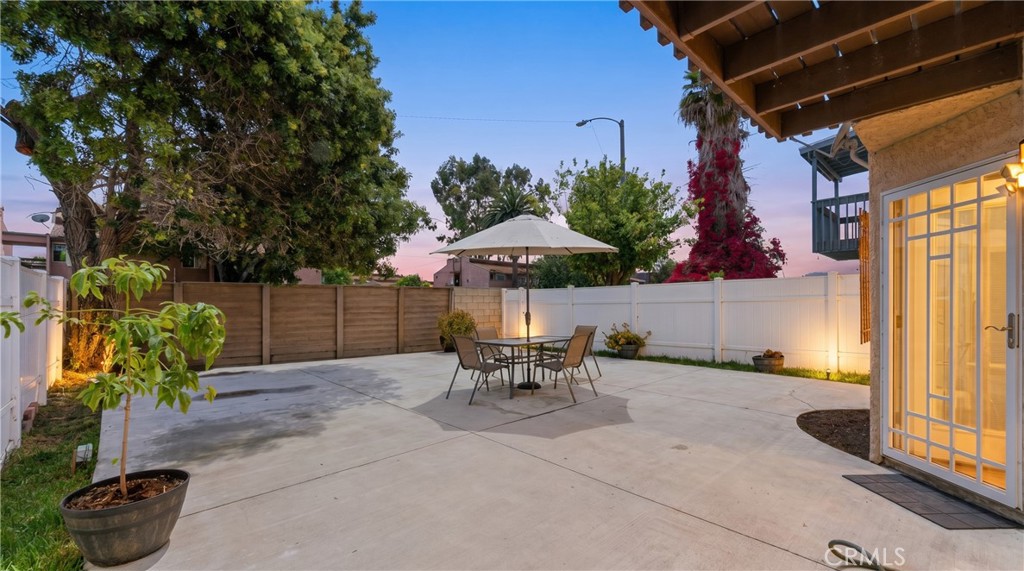 700 West Almond Street Compton, CA 90220 - Photo 68 of 68 a view of a patio with a table and chairs under an umbrella