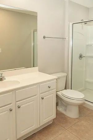 an aerial view of a house with outdoor space and lake view in back