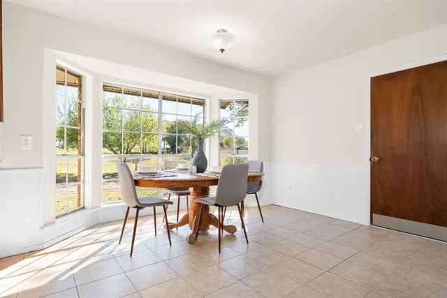 a dining room with furniture and window