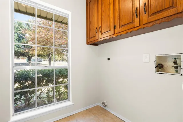 a view of a door with wooden floor and a cabinet