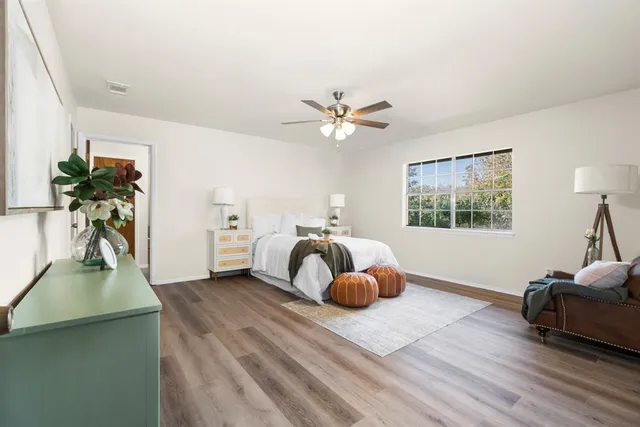 a bedroom with furniture and a window