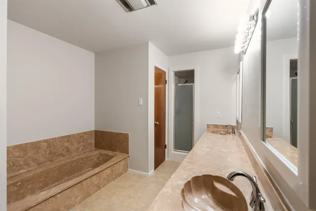 a en suite bathroom with a tub and shower