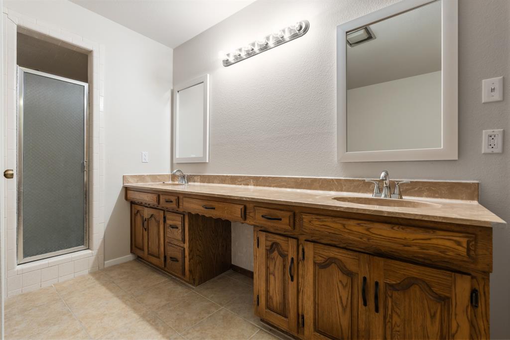 616 South Files Street Itasca, TX 76055 - Photo 21 of 37 a sink and a mirror