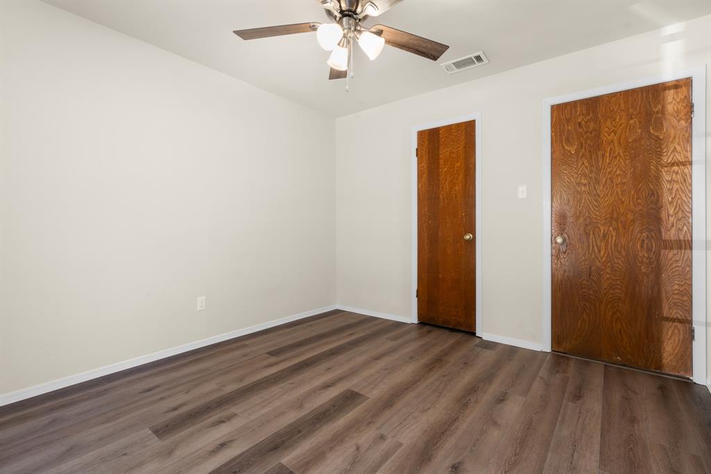 616 South Files Street Itasca, TX 76055 - Photo 23 of 37 an empty room with wooden floor closet and windows