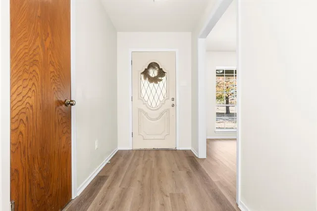 a view of a livingroom with wooden floor and a window