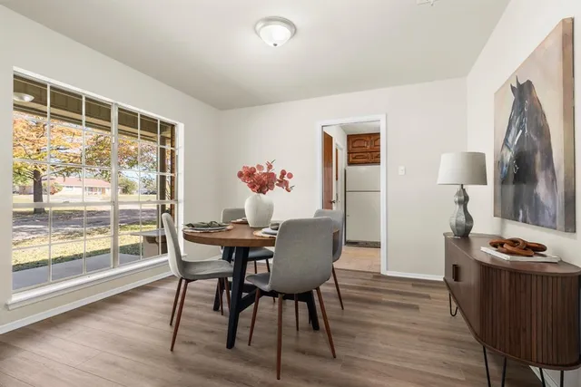 a view of a dining room with furniture window and wooden floor