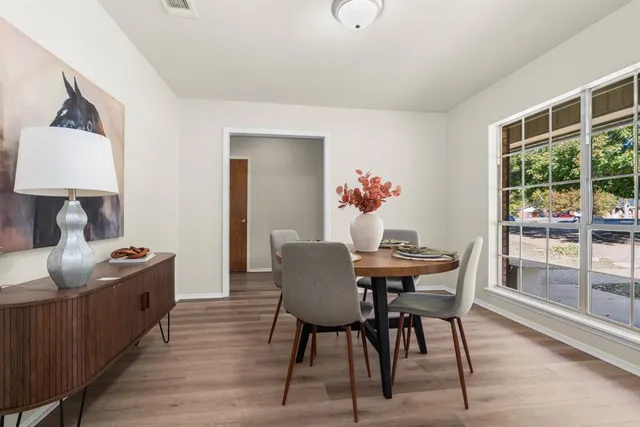 a view of a dining room with furniture and wooden floor