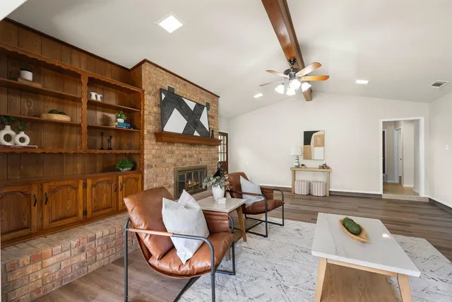 a living room with furniture a rug and a fireplace