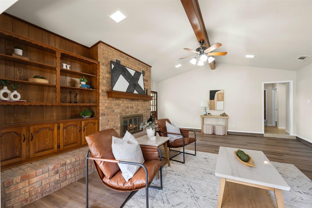 616 South Files Street Itasca, TX 76055 - Photo 9 of 37 a living room with furniture a rug and a fireplace