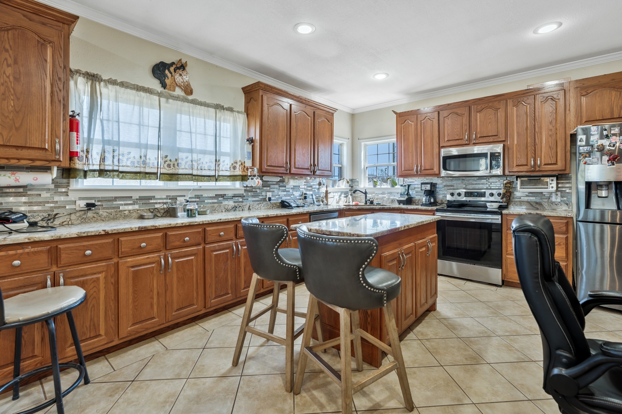 158 Big Springs Road Lawrenceburg, TN 38464 - Photo 27 of 54 a kitchen with stainless steel appliances granite countertop a sink a stove a refrigerator cabinets and chairs