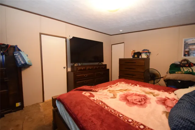 a bed room with a bed and a dresser