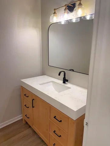 a bathroom with a sink and mirror