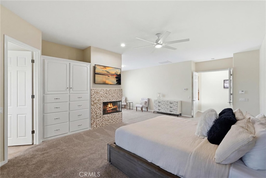 9 Orleans Road Rancho Mirage, CA 92270 - Photo 44 of 71 a bedroom with a bed and a ceiling fan