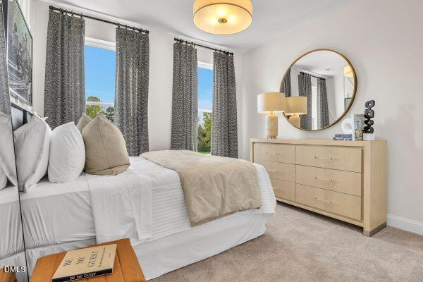 615 Hedrick Ridge Road, Unit 309 Cary, NC 27519 - Photo 13 of 18 a bedroom with a bed and a dresser