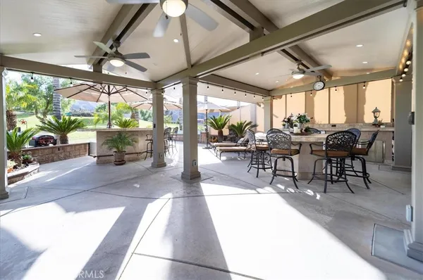 a outdoor space with lots of tables a garden view and furniture