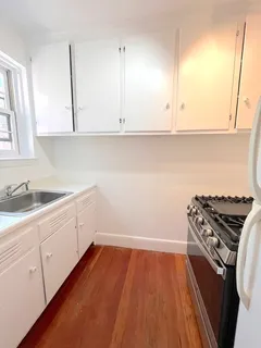 a kitchen with sink and cabinets
