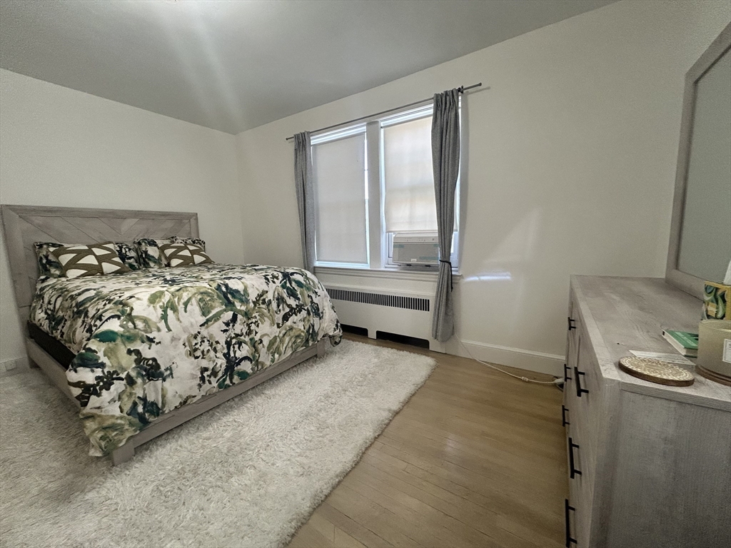 31 Park Street, Unit 6 Brookline, MA 02446 - Photo 9 of 13 a bedroom with a bed and a window