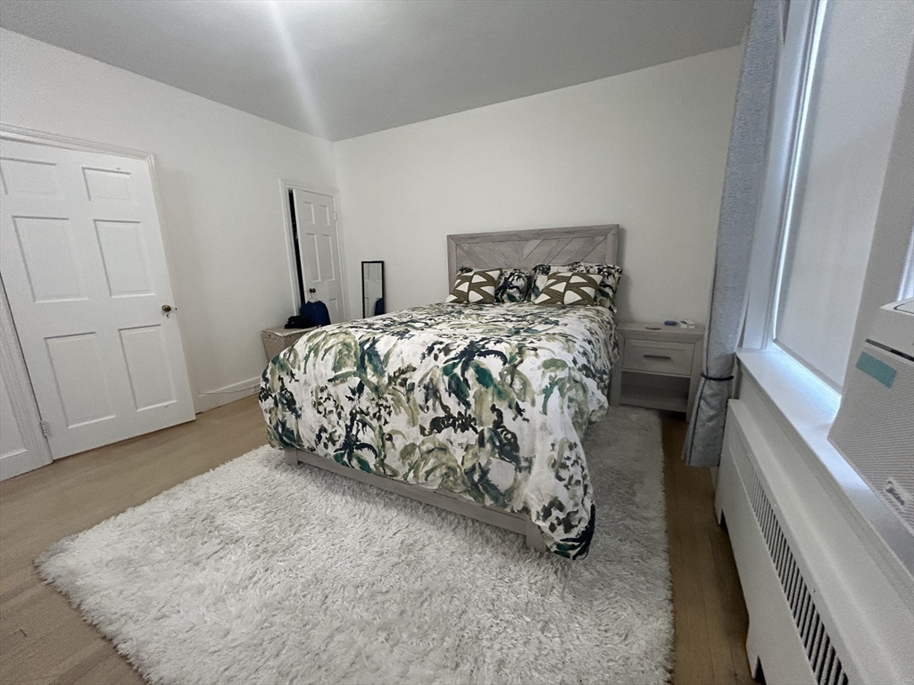 31 Park Street, Unit 6 Brookline, MA 02446 - Photo 10 of 13 a bed sitting in a bedroom next to a window