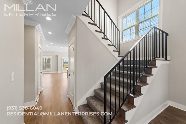 a view of entryway and hall with wooden floor