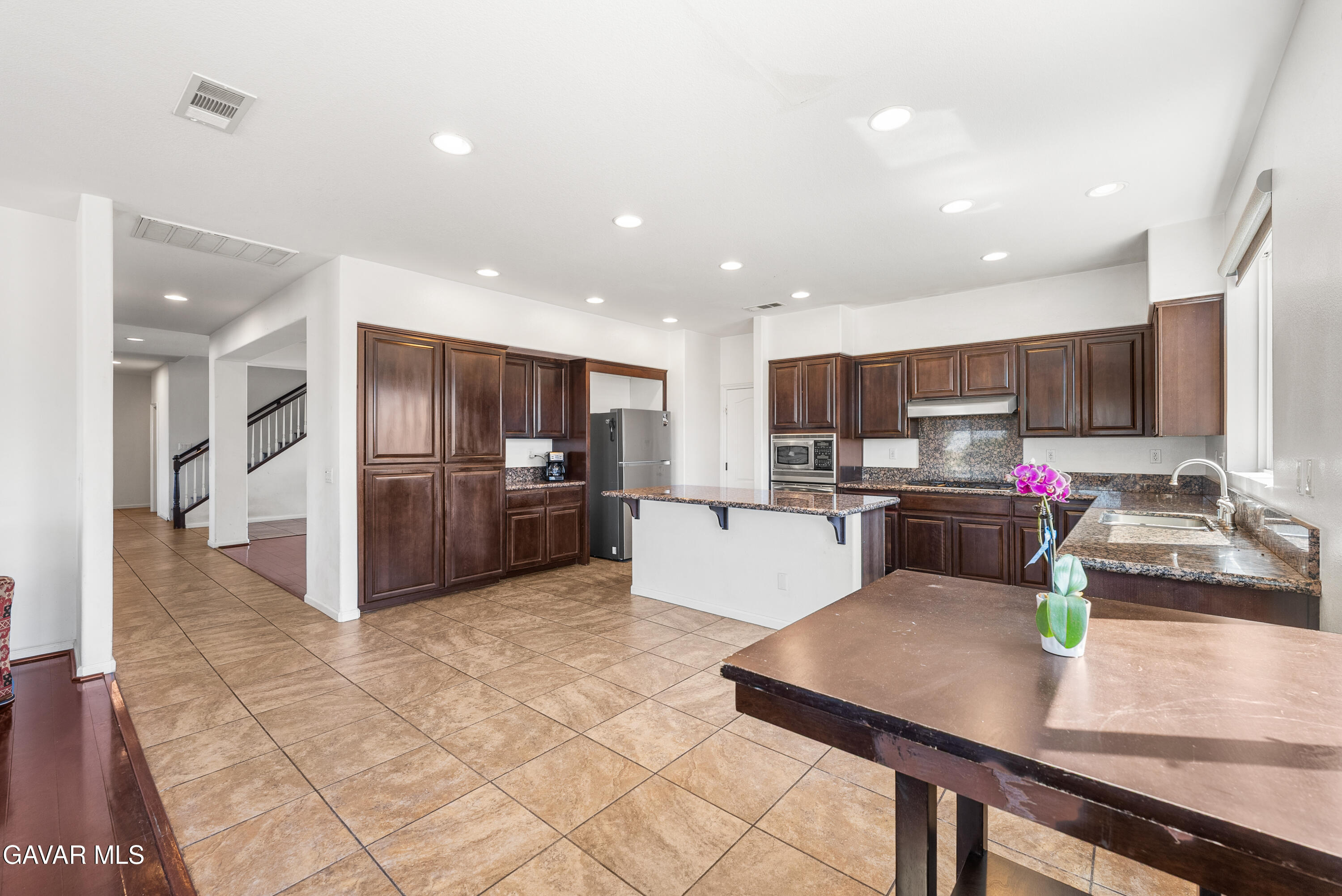 658 Lago Lindo Road Palmdale, CA 93550 - Photo 28 of 91 a kitchen with stainless steel appliances granite countertop a sink refrigerator and cabinets