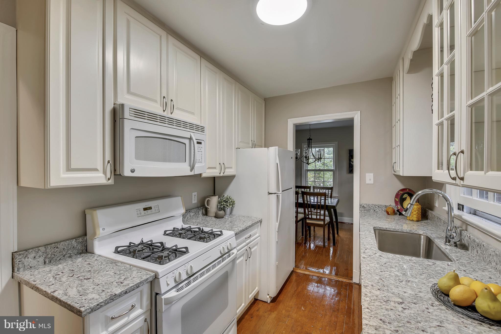 305 Wayne Place Silver Spring, MD 20910 - Photo 11 of 29 a kitchen with granite countertop a stove and a sink