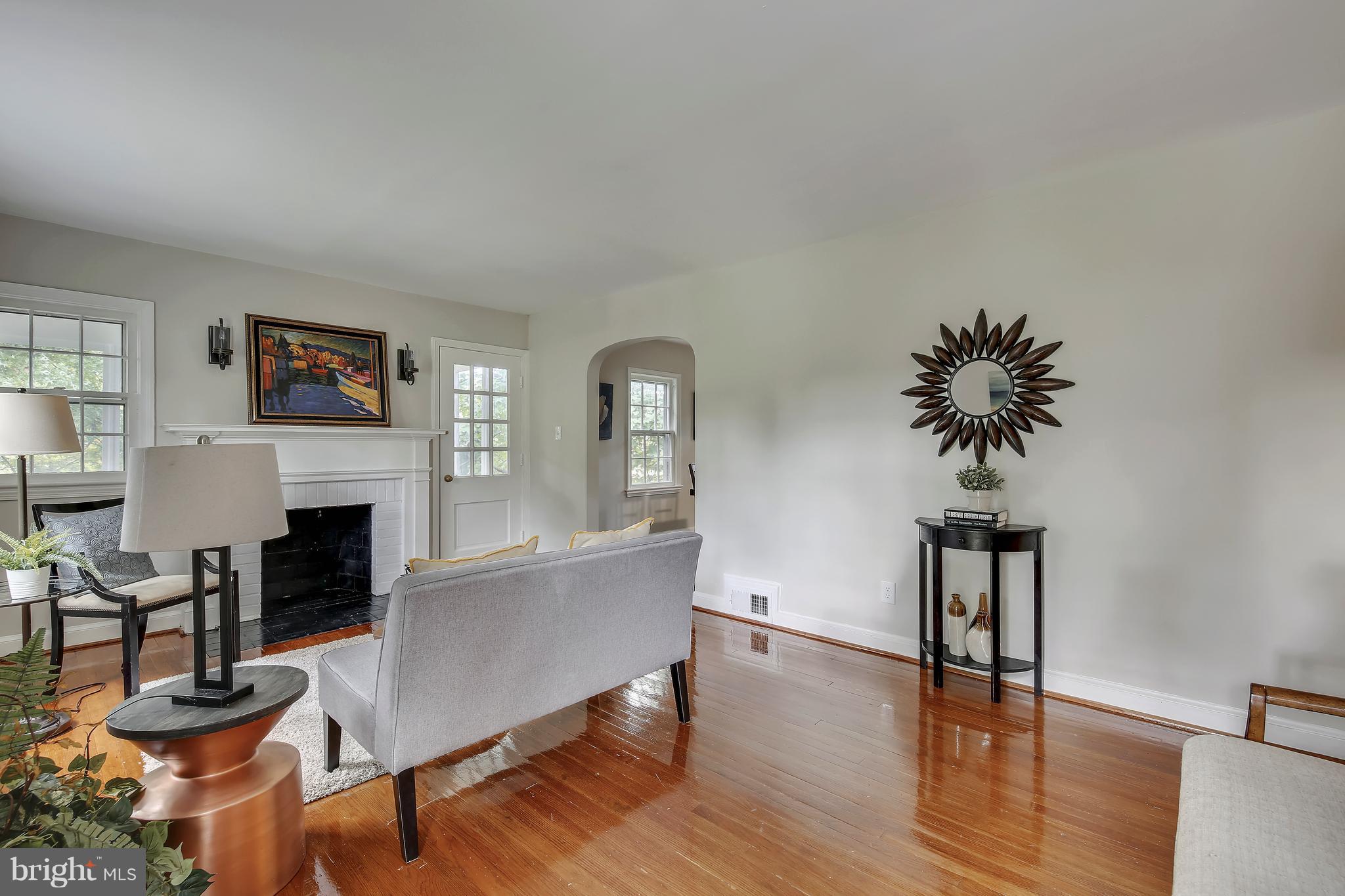 305 Wayne Place Silver Spring, MD 20910 - Photo 5 of 29 a living room with furniture a fireplace and a potted plant