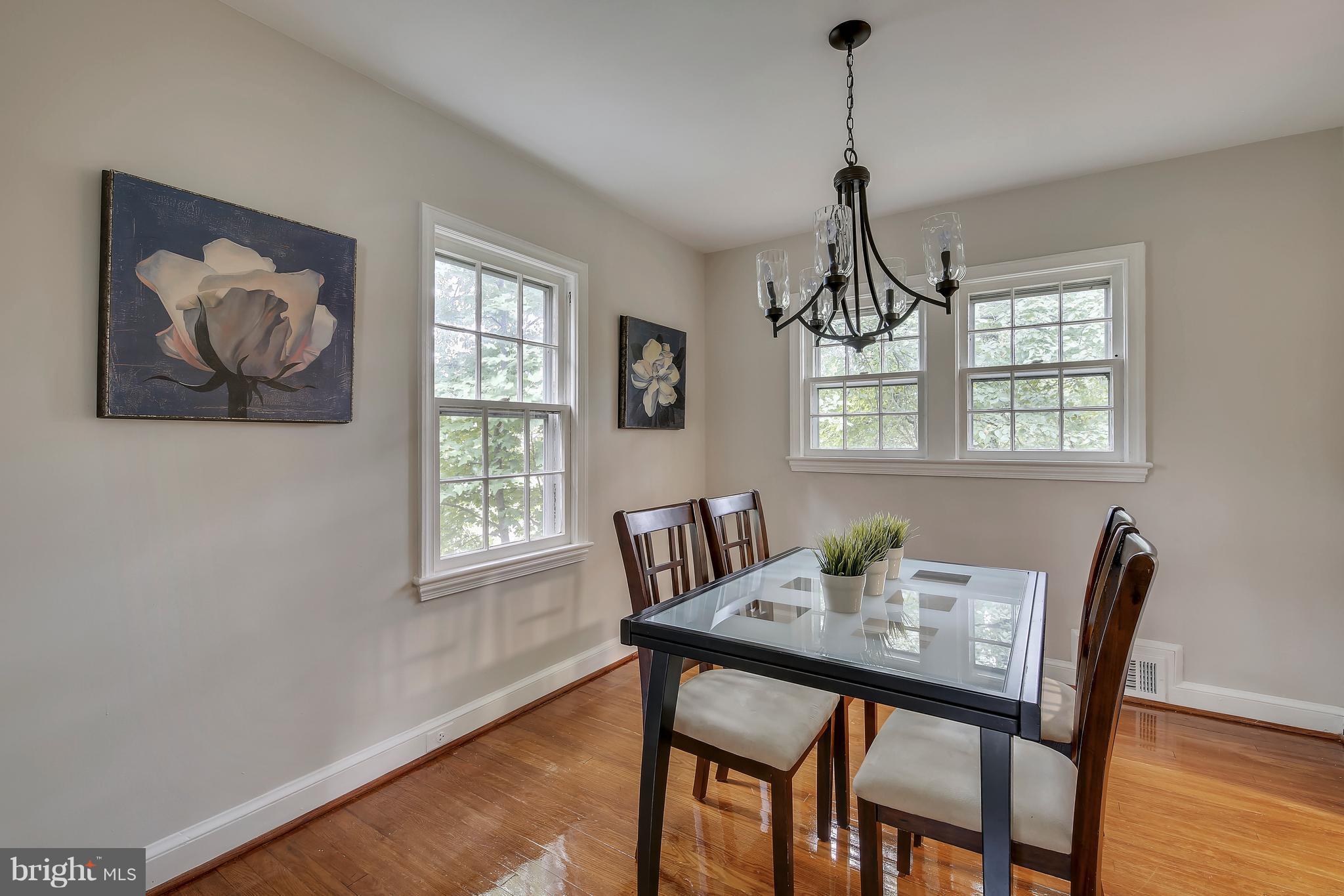 305 Wayne Place Silver Spring, MD 20910 - Photo 7 of 29 a dining room with furniture a window and wooden floor